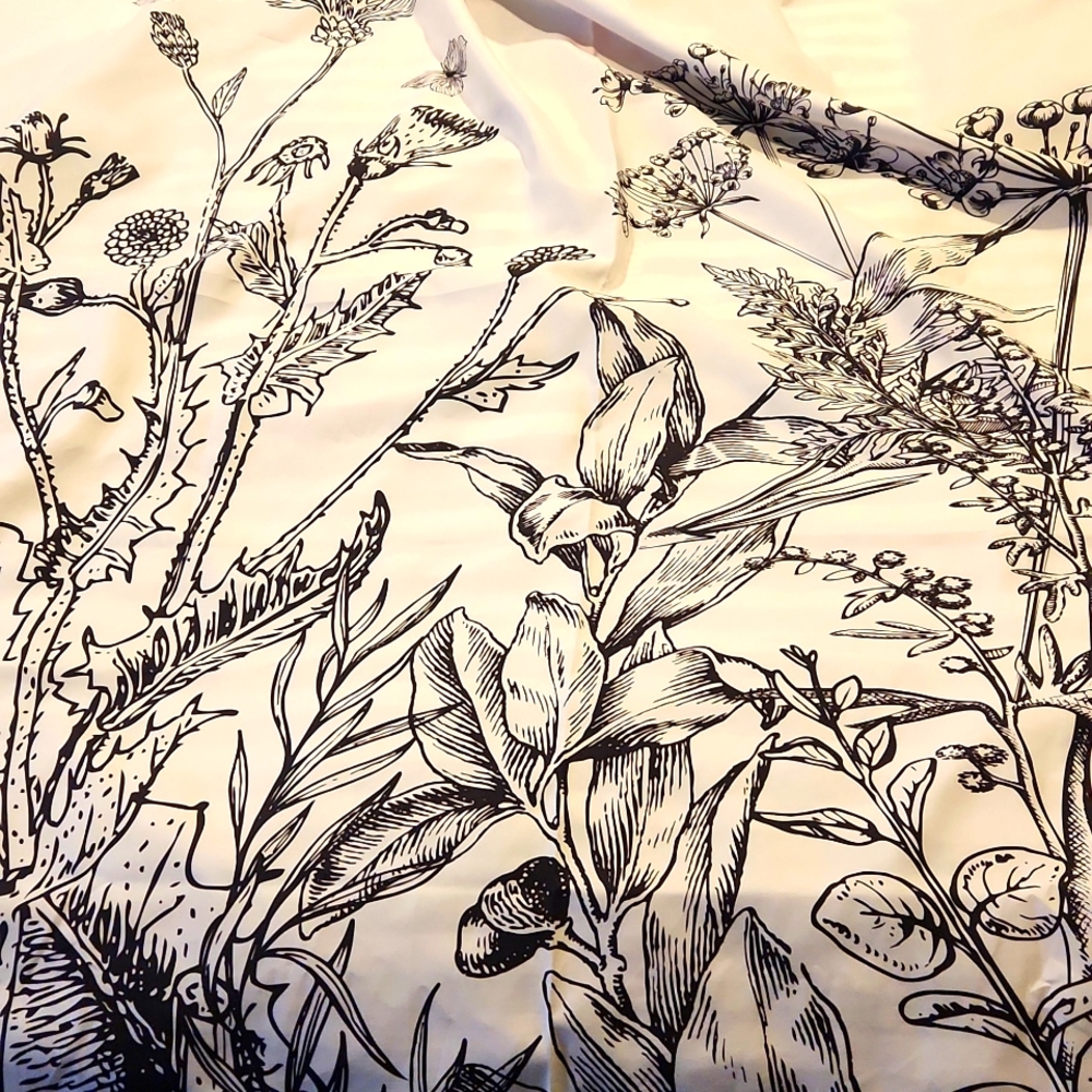 White and black tapestry with flower design